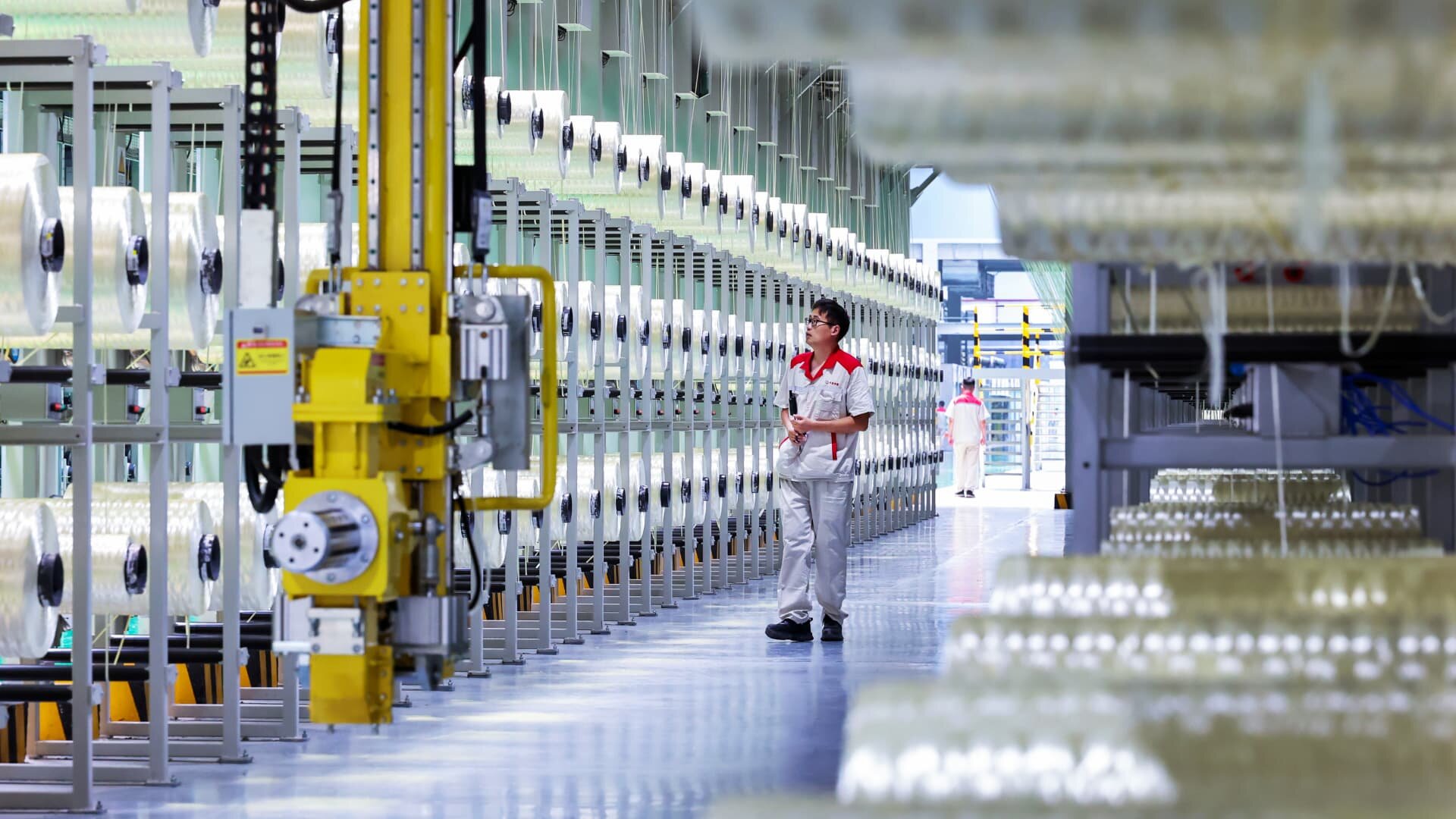 China factory activity grows faster than expected in June on tech export demand - CNBC