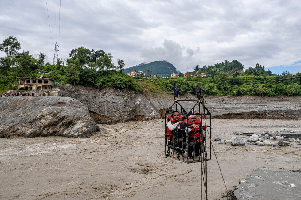 Trading food for medicine and crossing the river by zip line are part of life in Nepal flood zone - apnews.com